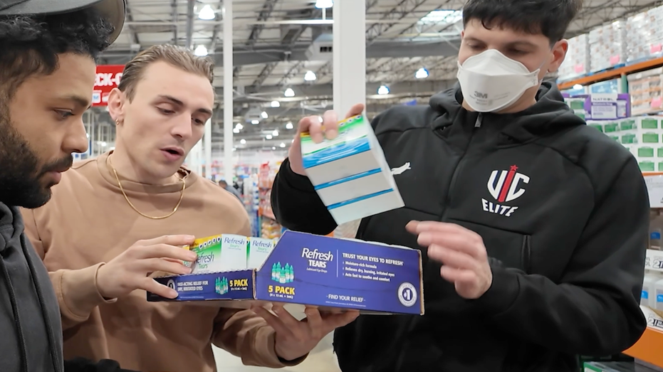 Three people gather around a box of eye drops