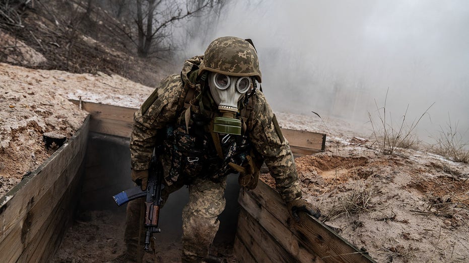 Ukrainian soldier wears gas mask