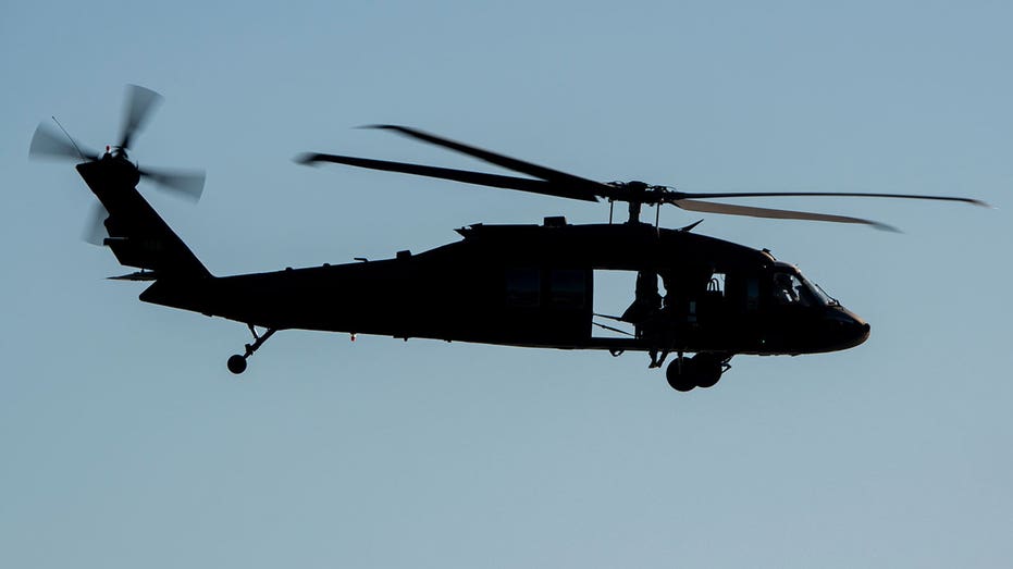 LAGUNA BEACH, CALIFORNIA - NOVEMBER 8: A U.S. Army Sikorsky UH-60 Black Hawk helicopter flies along the coast on November 8, 2024, in Laguna Beach, California. (Photo by Kevin Carter/Getty Images)