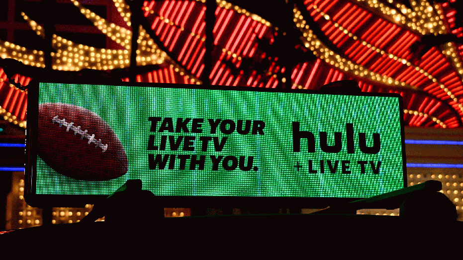 The Walt Disney Co. Hulu Plus Live TV steaming service logo is displayed on a taxi advertisement ahead of Super Bowl LVIII in Las Vegas, Nevada on February 7, 2024. (Photo by Patrick T. Fallon / AFP) (Photo by PATRICK T. FALLON/AFP via Getty Images)