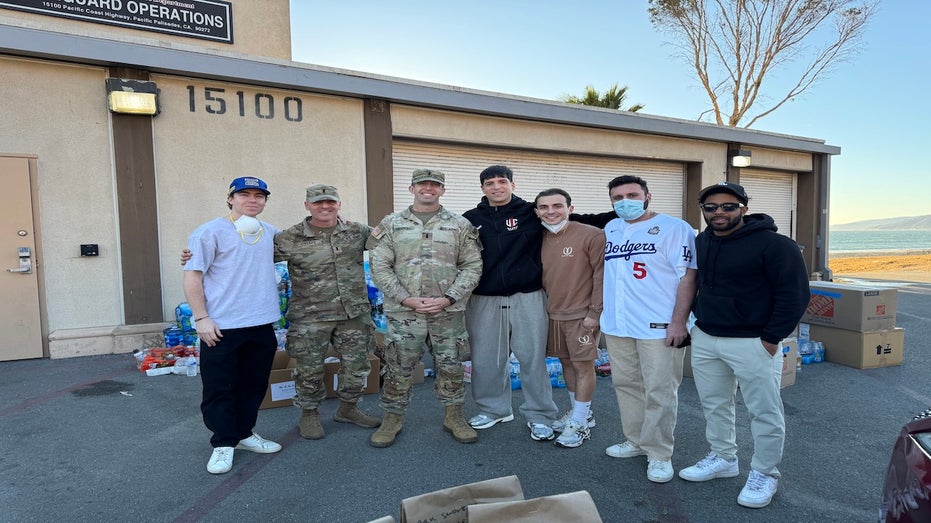 A group of people take pictures in front of the rescue building