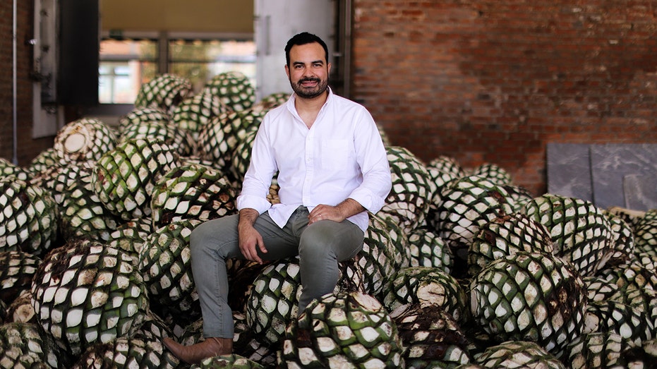 Lalo Gonzalez, grandson of Don Julio, sitting on agave