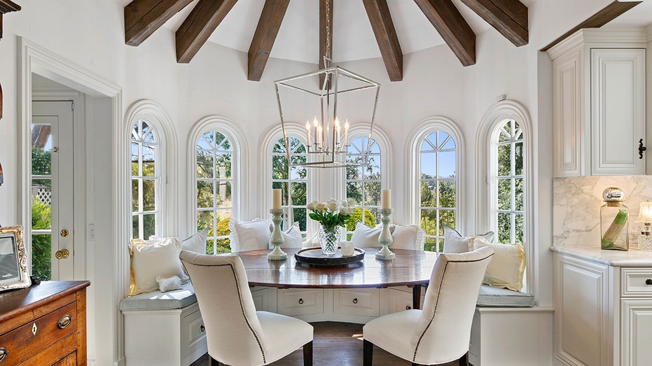 Only the steps from the kitchen island is a nook breakfast, which is located under a large window.