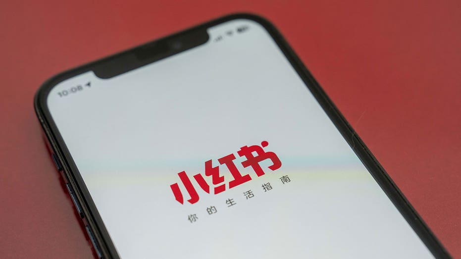 The Xiaohongshu logo was arranged on an Apple Inc. iPhone. in Shanghai, China, Thursday, Jan. 16, 2025. A pair of Chinese-made social apps, Xiaohongshu and Lemon8, have taken the top two positions on Apple's iPhone download charts in the US as users search alternatives to TikTok before an imminent ban. Photographer: Raul Ariano/Bloomberg via Getty Images