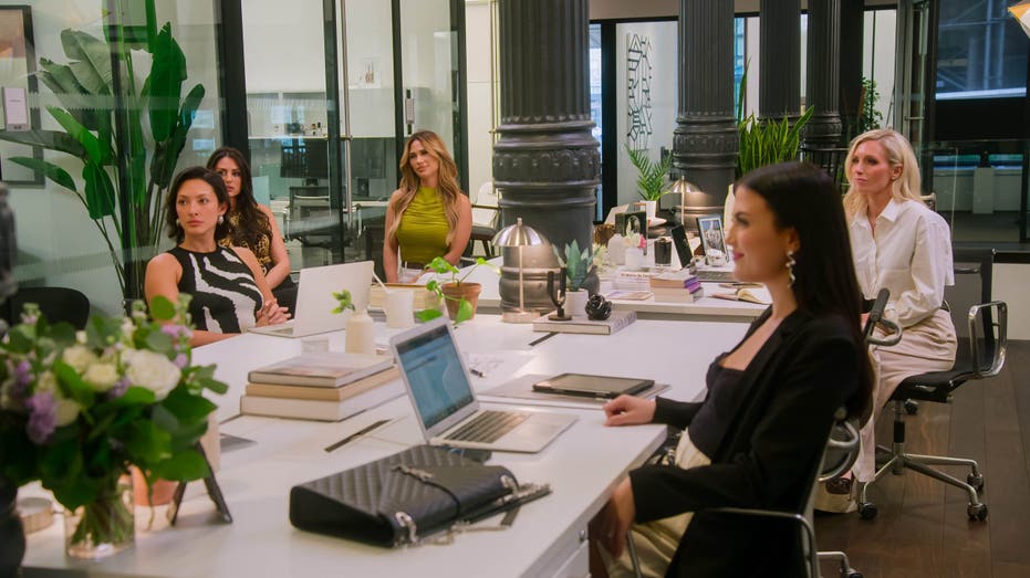 the selling the city cast at a work meeting