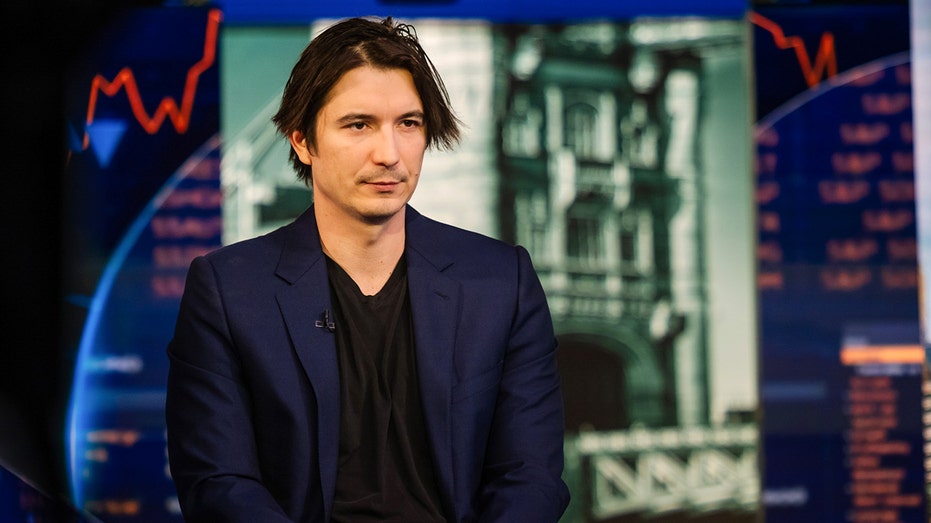 Vlad Tenev in front of market trading background