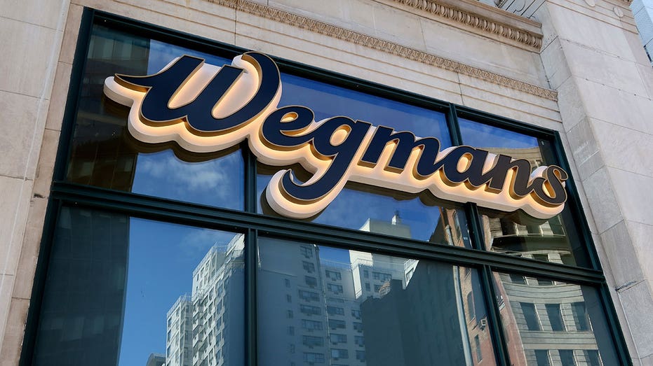 NEW YORK, NY - OCTOBER 28: The Wegmans corporate logo hangs outside their Astor Place grocery store on October 28, 2023, in New York City. (Photo by Gary Hershorn/Getty Images)