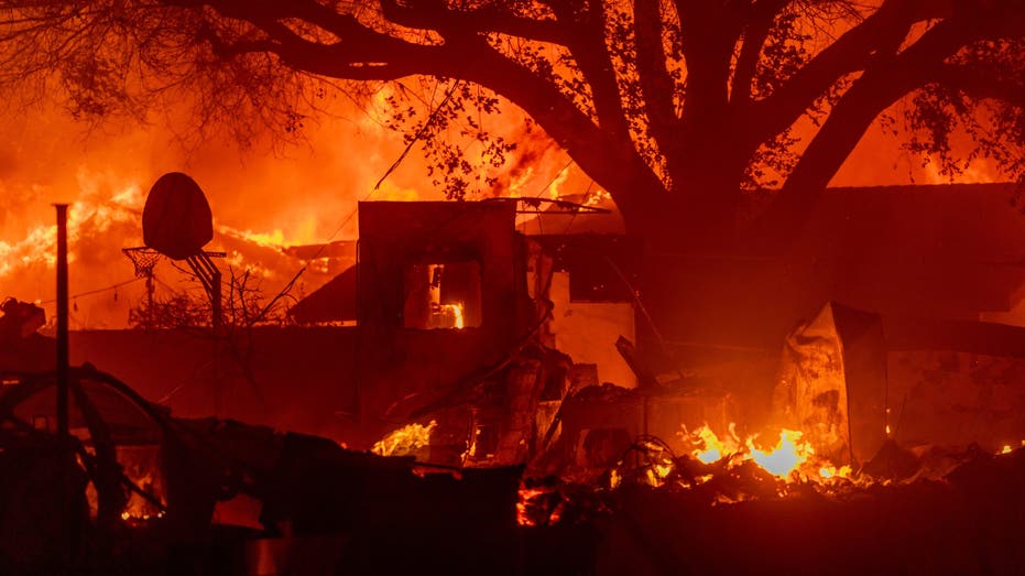 PASADENA, CALIFORNIA - JANUARY 7: Homes burn as strong winds fan the Eaton Fire on January 7, 2025 in Pasadena, Calif. A powerful Santa Ana wind event has dramatically increased the risk of dangerous wind-driven wildfires like the one near Santa Monica. and the devastating Palisades fire.Strong winds as well forced President Joe Biden to cancel his plans to travel between Los Angeles and Riverside, California (Photo by David McNew/Getty Images)