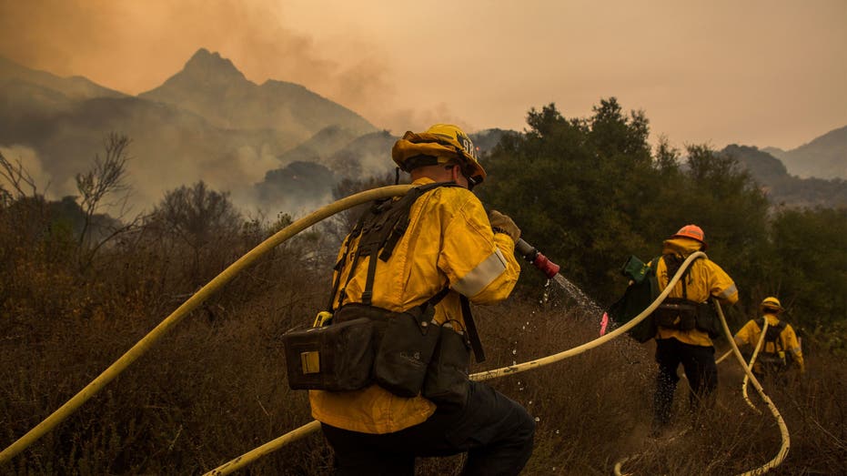 MALIBU, CA - NOVEMBER 10: Los Angeles County firefighters battle flames approaching the Salvation Army camp at Malibu Creek State Park during the Woolsey Fire on November 10, 2018 near Malibu, California. The Woolsey fire has burned more than 70,000 acres and has reached the Pacific coast of Malibu as it continues to grow. (Photo by David McNew/Getty Images)