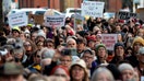 Demonstrators hold signs during a protest against Elon Musk outside the U.S. Treasury building in Washington, D.C., on Tuesday, Feb. 4.