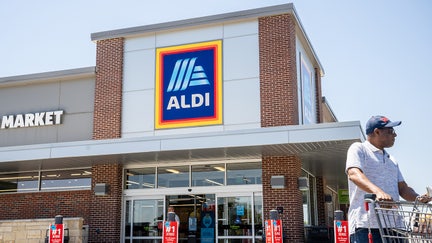 A customer walks out of an Aldi supermarket on August 17, 2023 in Pflugerville, Texas.