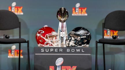 NEW ORLEANS, LOUISIANA - FEBRUARY 03: A detail shot of the Lombardi Trophy next to Kansas City Chiefs and Philadelphia Eagles helmets prior to a news conference on February 03, 2025 in New Orleans, Louisiana ahead of the NFL Super Bowl LIX football game between the Philadelphia Eagles and the Kansas City Chiefs. (Photo by Michael Owens/Getty Images)
