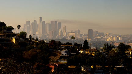 A layer of smog lingers above the downtown Los Angeles skyline on December 6, 2024. The National Weather Service on December 4 issued an air quality alert for the greater Los Angeles area until midnight on December 6. (Photo by ETIENNE LAURENT / AFP) (Photo by ETIENNE LAURENT/AFP via Getty Images)  - Fox Business News
