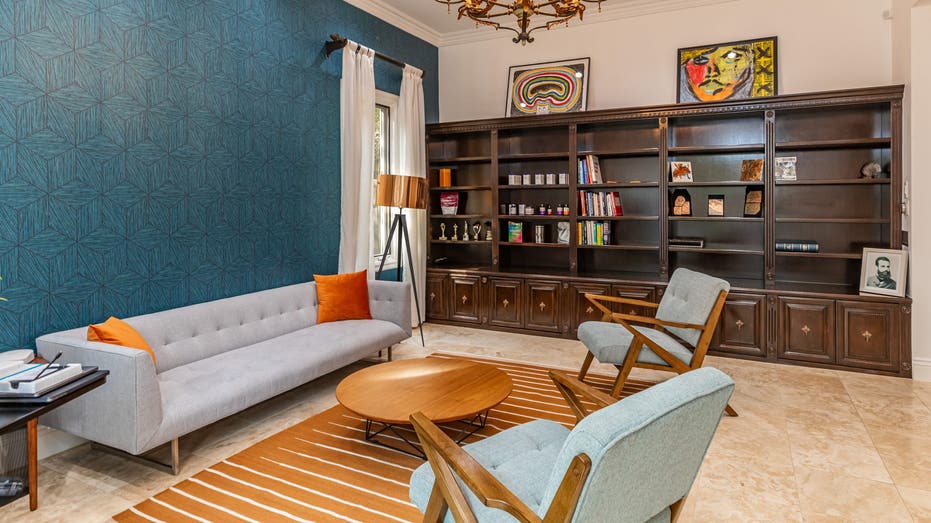 Living room with chandelier and blue wall