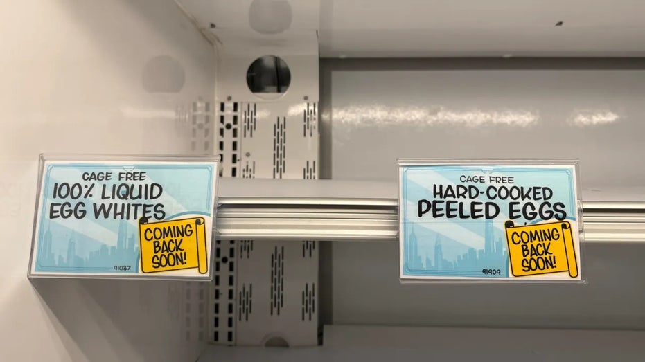 Placards on a store shelf inform customers that cage free eggs are coming back soon.