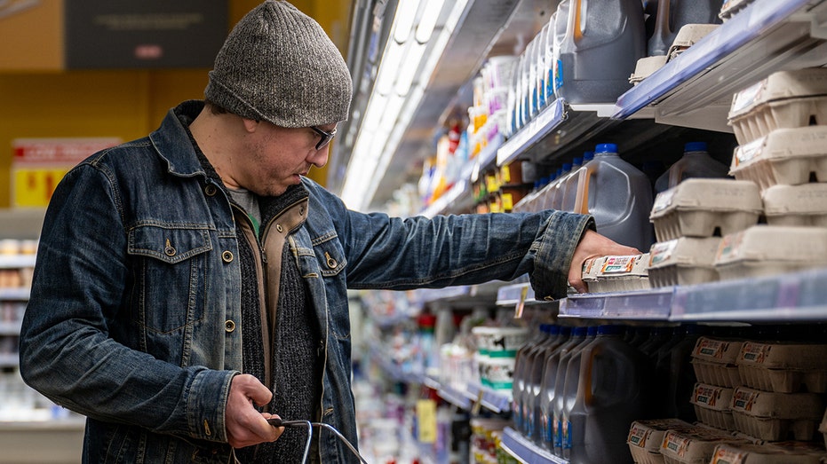 The shopper looks at the eggs