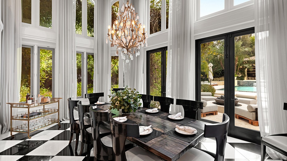 The dining room has ceiling floor windows and a space enough for a table table for 10 people.