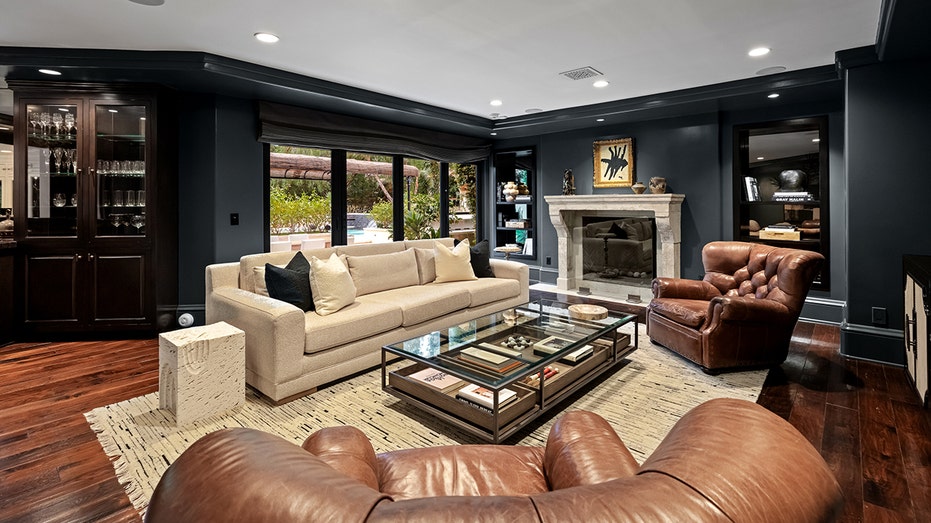 The home also features a less formal sitting area, with a large flat-screen TV and a fireplace.