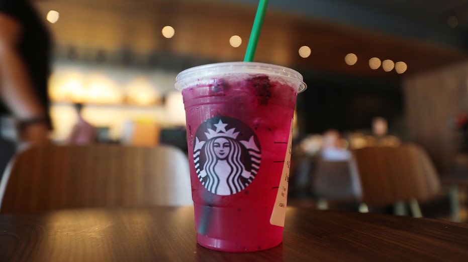 plastic Starbucks cup carrying bright pink cold drink