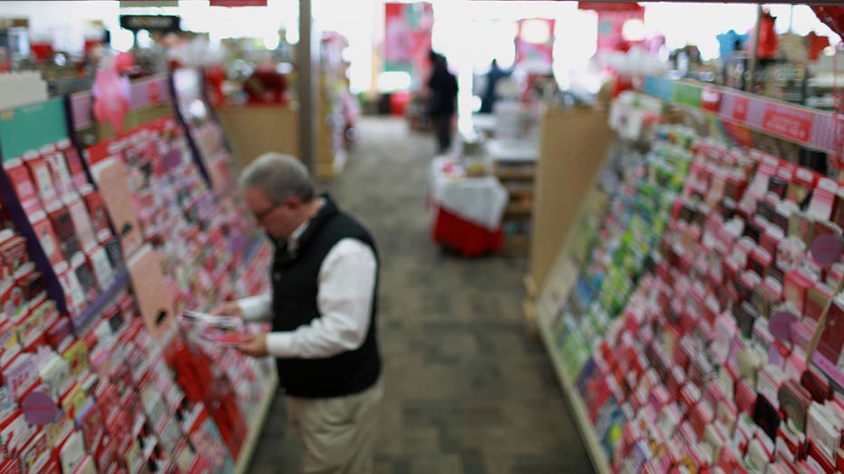 A sign reminds customers about the date of Valentine's Day as they browse greeting cards at a Hallmark Cards Inc. Gold Crown retail store in Knoxville, Tennessee, U.S., on Tuesday, Feb. 10, 2015. The U.S. Census bureau is expected to release monthly retail sales data on Feb. 12. Photographer: Luke Sharrett/Bloomberg via Getty Images
