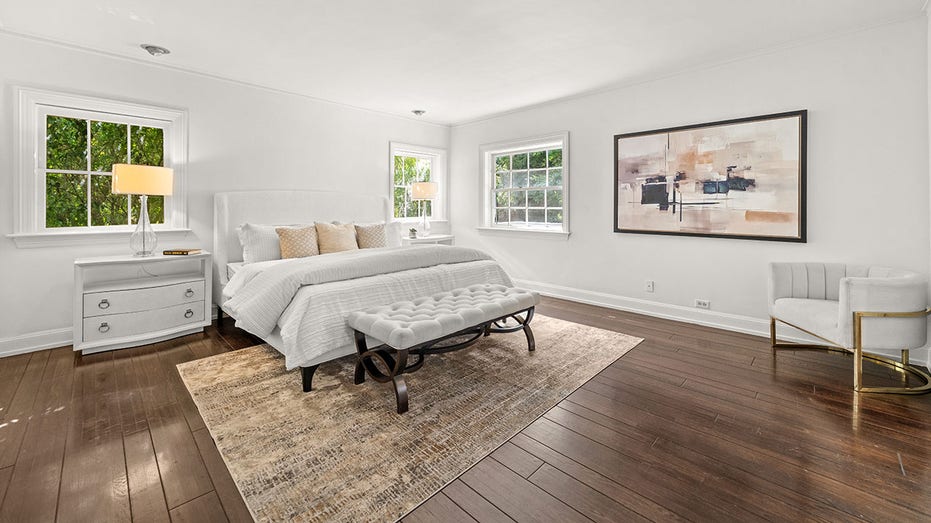 The primary bedroom features multiple windows and an ensuite bathroom.