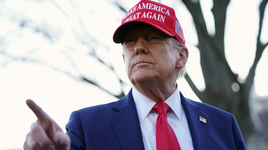 President Donald Trump speaks with journalists