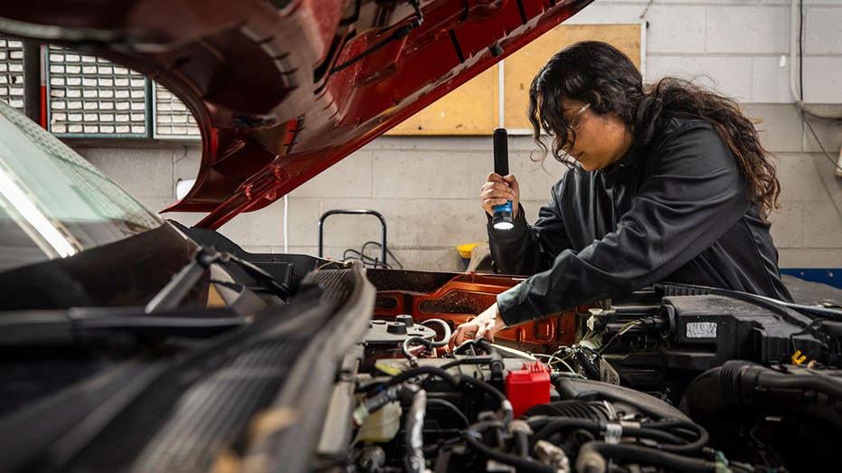 An auto tech student working on a vehicle