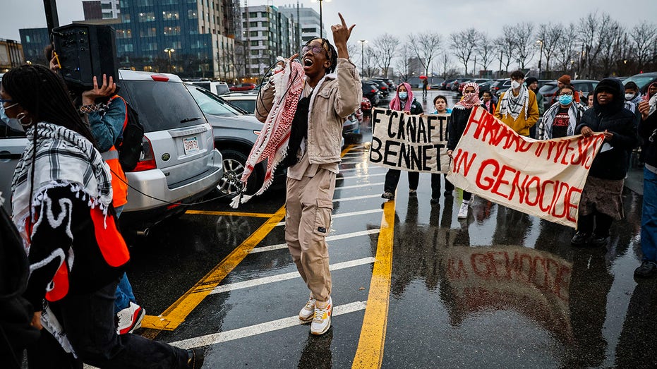 Ant-Israel protesters wave Palestinian flags during march on Harvard's campus