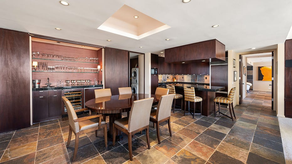 Connected to the kitchen is the dining area with a wooden table fit for six.