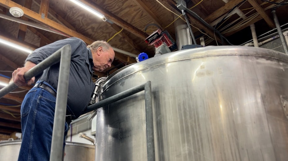Phjil prichard watches his rum in the distilling process.