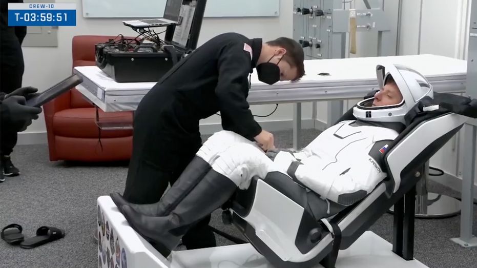 SpaceX Crew-10 astronauts prepare in the suit-up room on Friday.