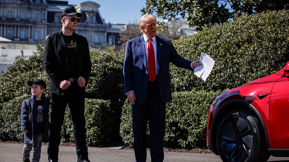 Trump speaks to the picture while buying a tesla of Elon Musk