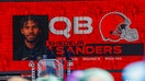 A graphic announcing Colorado quarterback Shedeur Sanders&rsquo; selection by the Cleveland Browns with the 144th overall pick is seen in the Draft Theater during the third day of the 2025 NFL Draft at Lambeau Field. 