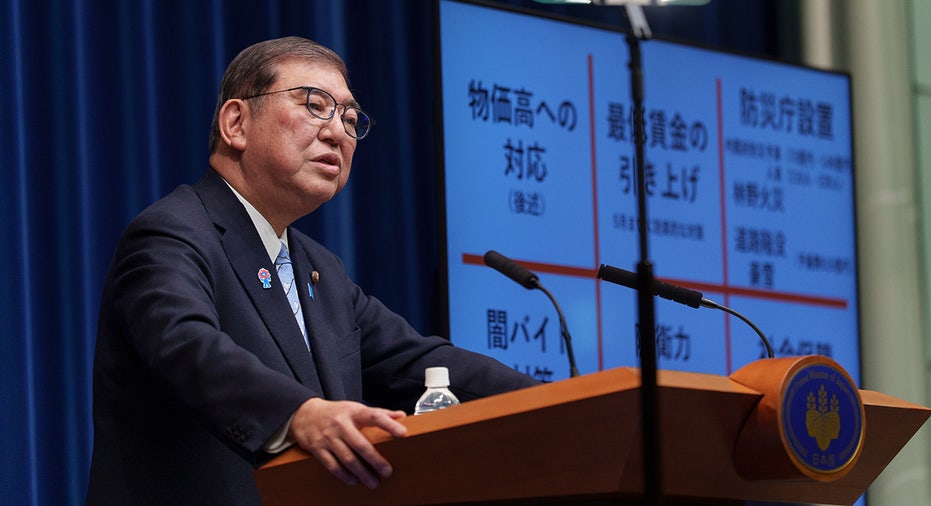 Shigeru Ishiba stands at podium while speaking