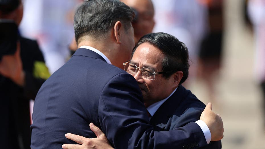 Chinese President Xi Jinping hugs Vietnamese Prime Minister Pham Minh Chinh as he leaves to board his plane for departure following his visit to Hanoi at Noi Bai International Airport in Vietnam, April 15, 2025. REUTERS/Athit Perawongmetha/Pool