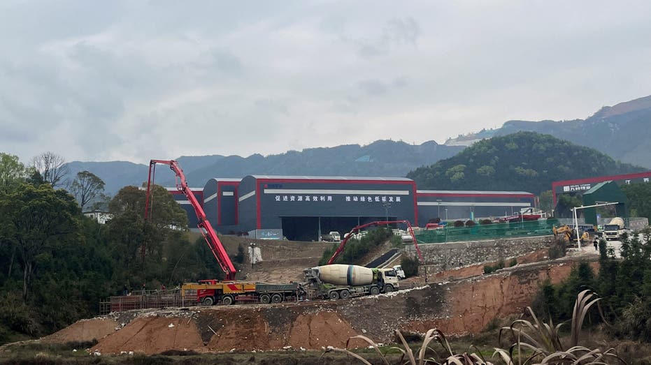 Workers and vehicles are seen at a lithium smelter in Yichun, Jiangxi province, China March 30, 2023. 