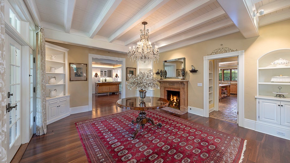 The living room features a wood-burning fireplace and multiple built-in shelves.