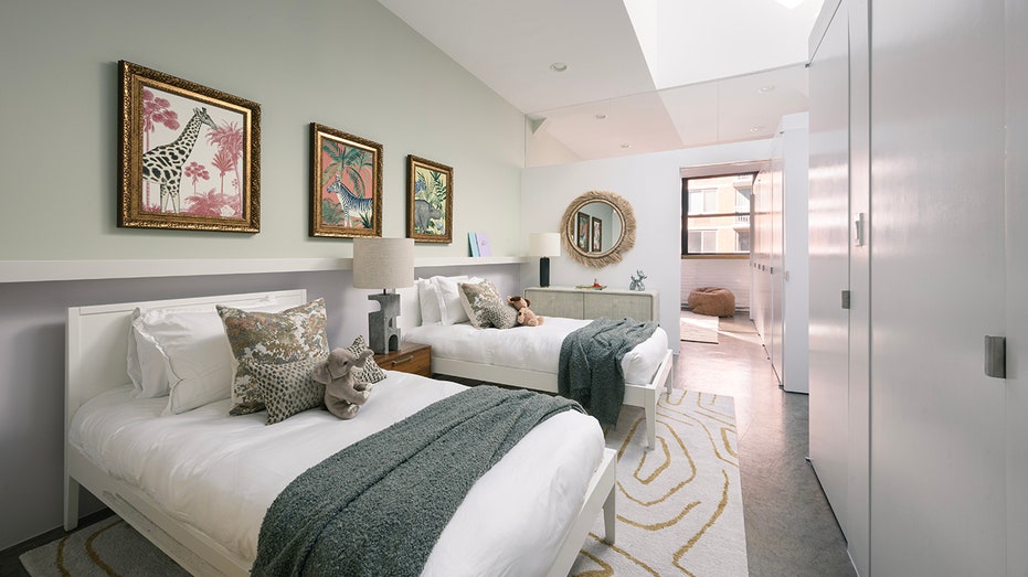 A third bedroom features two full beds and animal paintings on the walls.