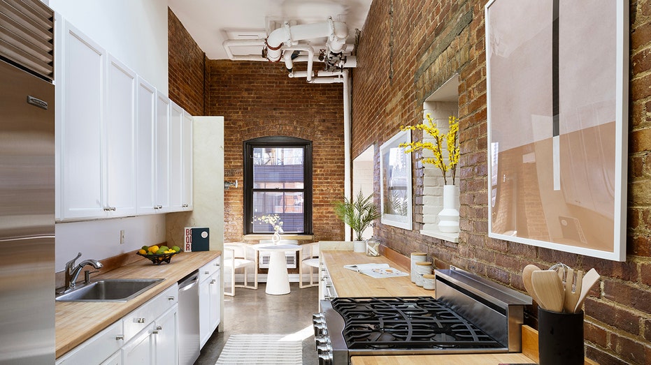 The kitchen features butcher block countertops and a sub-zero refrigerator.