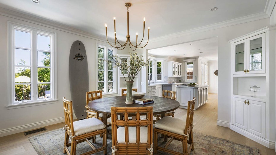 The dining room features built-in shelving for extra storage and a door leading to the front porch.