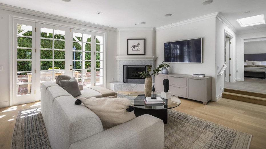 Steps away from the dining area is the living room which features a fireplace.