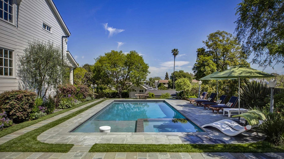 The yard also features a swimming pool.
