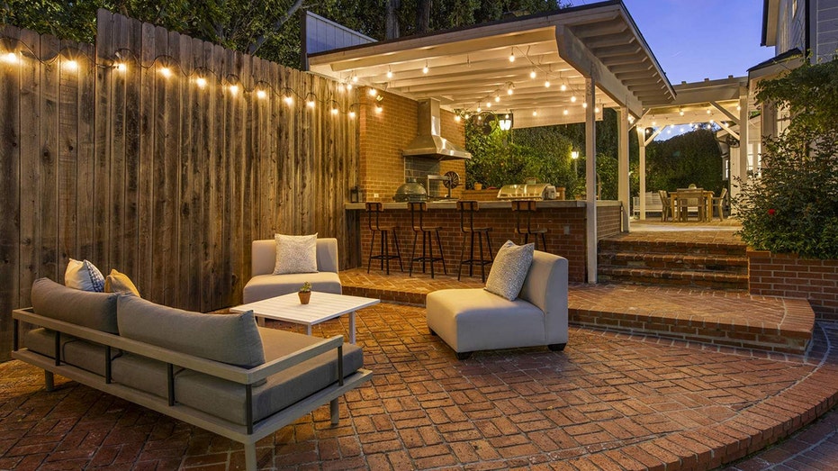 Just steps away from the kitchen is a brick courtyard and outdoor seating area.