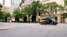 An all-electric, fully autonomous ID. Buzz AD vehicle driving in the street.
