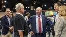 Greg Abel, chairman of Berkshire Hathaway Energy, center, during a shareholders shopping day ahead of the Berkshire Hathaway annual meeting in Omaha, Nebraska, U.S., on Friday, April 29, 2022. After hanging in the shadows for most of the pandemic, Warren Buffett and his deputies have been ramping up Berkshire Hathaway Inc.s acquisition machine -- snapping up shares of Occidental Petroleum Corp. and HP Inc. and striking an $11.6 billion deal to buy Alleghany Corp. Photographer: Dan Brouillette/Bloomberg via Getty Images
