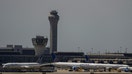 The control tower is pictured as planes are seen on the tarmac after an air traffic control outage, bringing flights to a standstill at Newark International Airport in Newark, New Jersey, U.S., May 11, 2025.