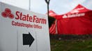 The State Farm Insurance logo is displayed on a sign near a mobile catastrophe office following wildfires that destroyed thousands of homes in Los Angeles, California, on February 21, 2025. California&apos;s insurance commissioner last week denied State Farm an &quot;emergency&quot; rate increase of 22 percent due to the Los Angeles area wildfires including the Palisades Fire and Eaton Fire.