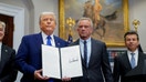 President Donald Trump holds an executive order on prescription drug pricing next to U.S. Health and Human Services (HHS) Secretary Robert F. Kennedy, Jr., during a press conference in the Roosevelt Room at the White House in Washington, D.C., on May 12, 2025.