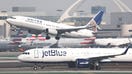 LOS ANGELES, CALIFORNIA - JANUARY 03: A JetBlue plane taxis after landing as a United plane takes off at Los Angeles International Airport (LAX) on January 03, 2025 in Los Angeles, California. JetBlue has been fined $2 million by the Department of Transportation for ‘operating multiple chronically delayed flights’ which marks the first time an airline has received such a penalty. (Photo by Mario Tama/Getty Images)
 - Fox Business News