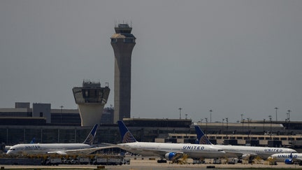 The control tower is pictured as planes are seen on the tarmac after an air traffic control outage, bringing flights to a standstill at Newark International Airport in Newark, New Jersey, U.S., May 11, 2025.
